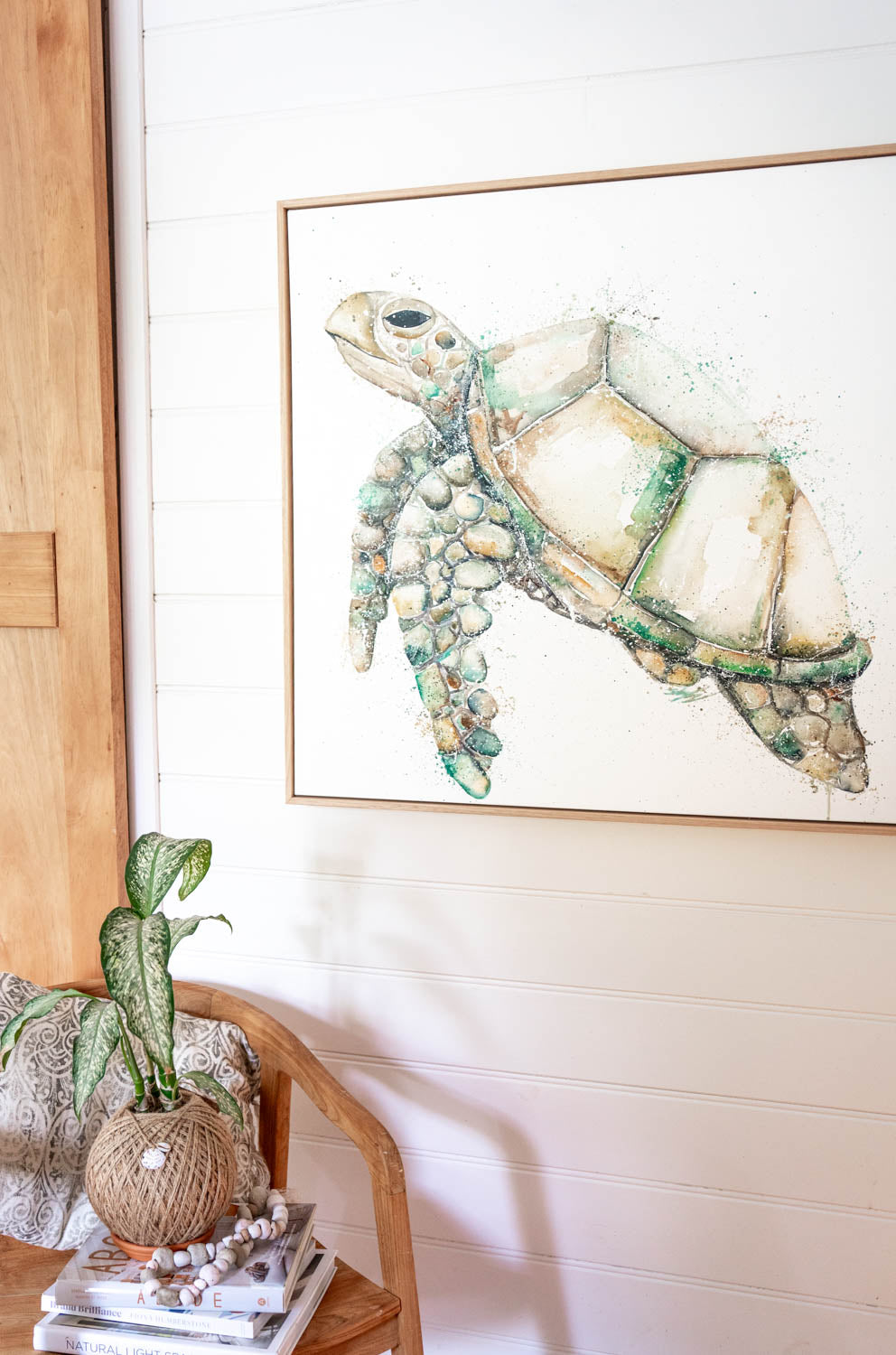 turtle canvas artwork hanging on wall in oak frame