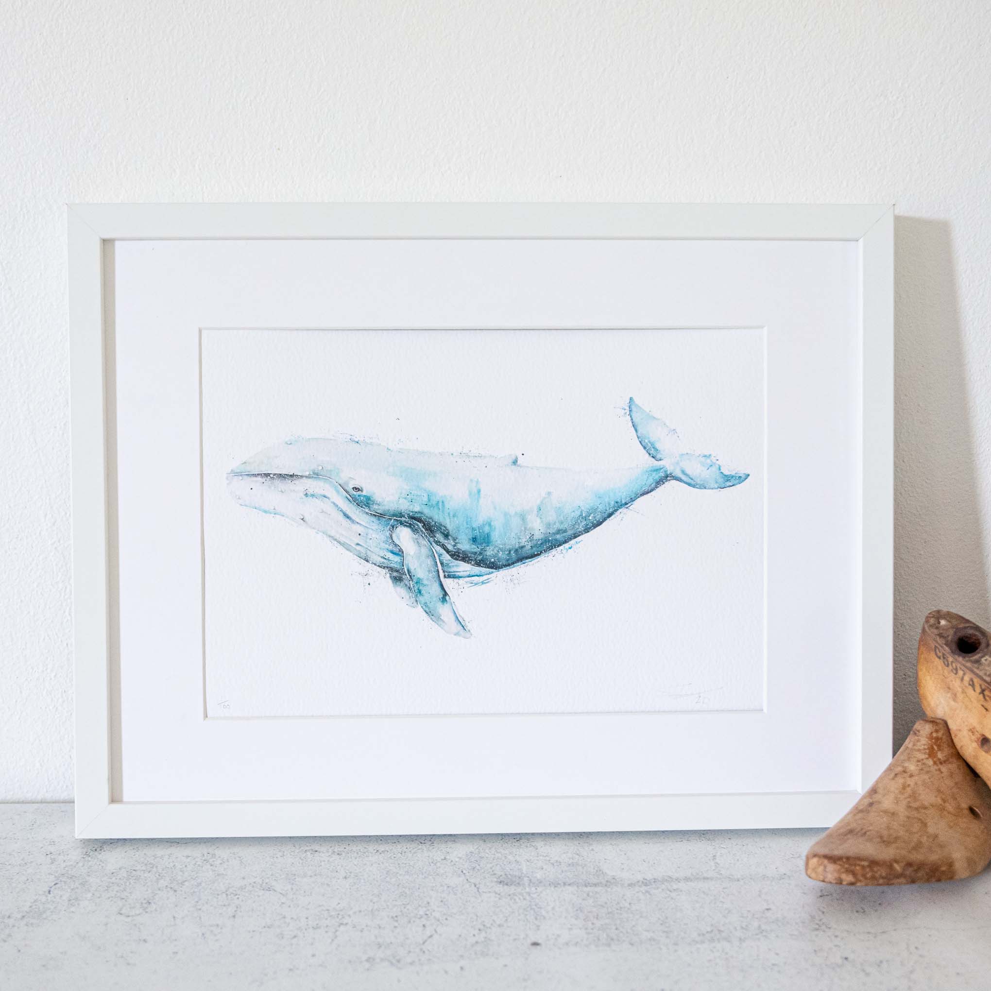 Framed white artwork of a humpback whale