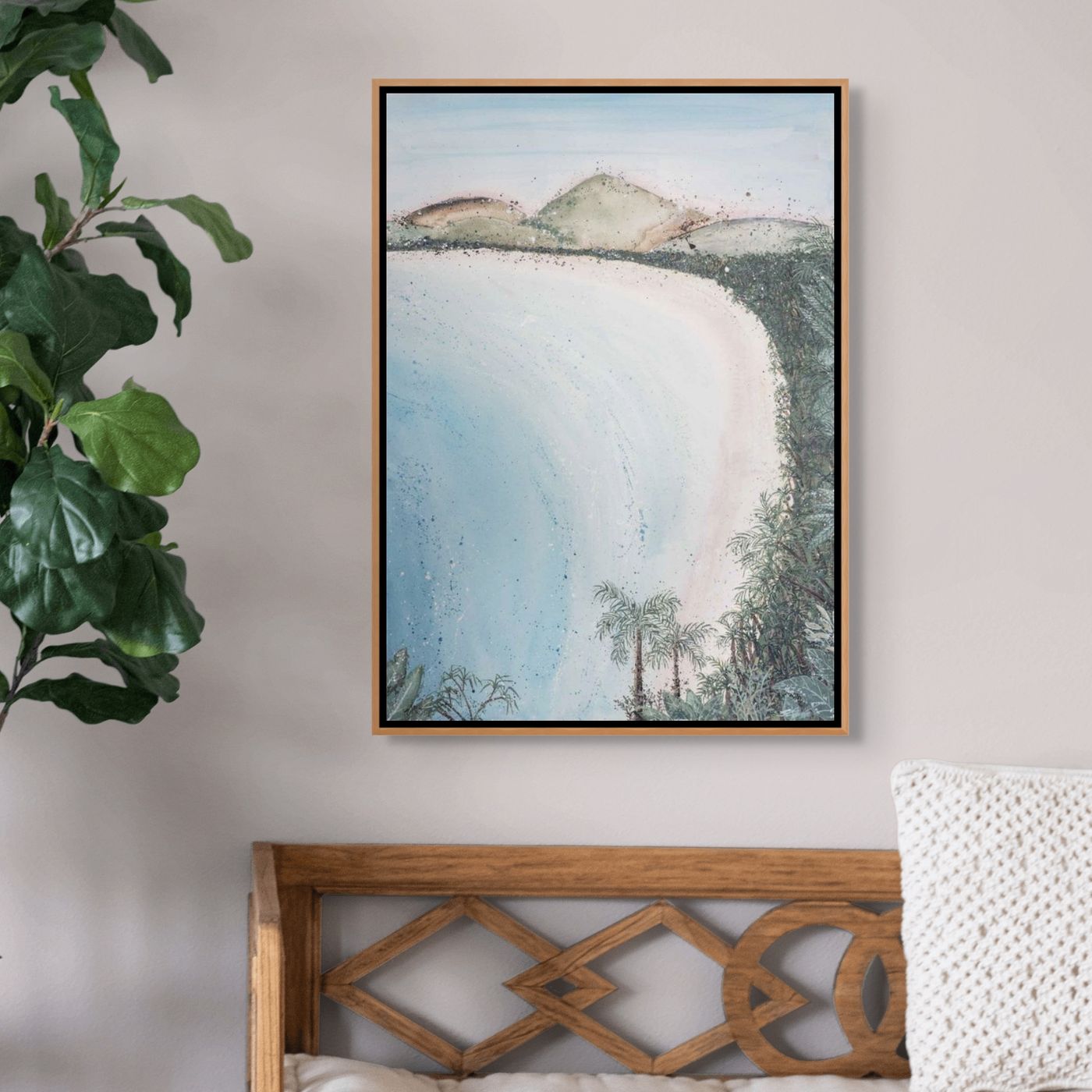 Framed landscape painting on a wall above a wooden headboard with a plant to the left.