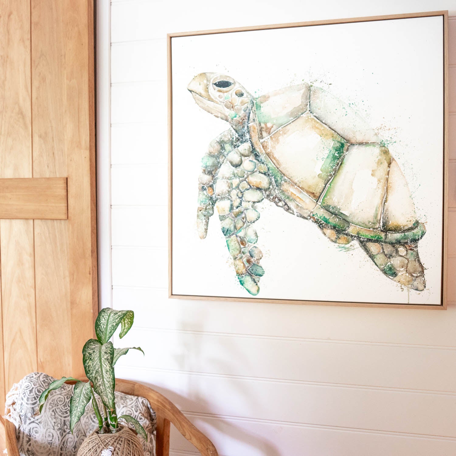 turtle canvas artwork hanging on wall in oak frame