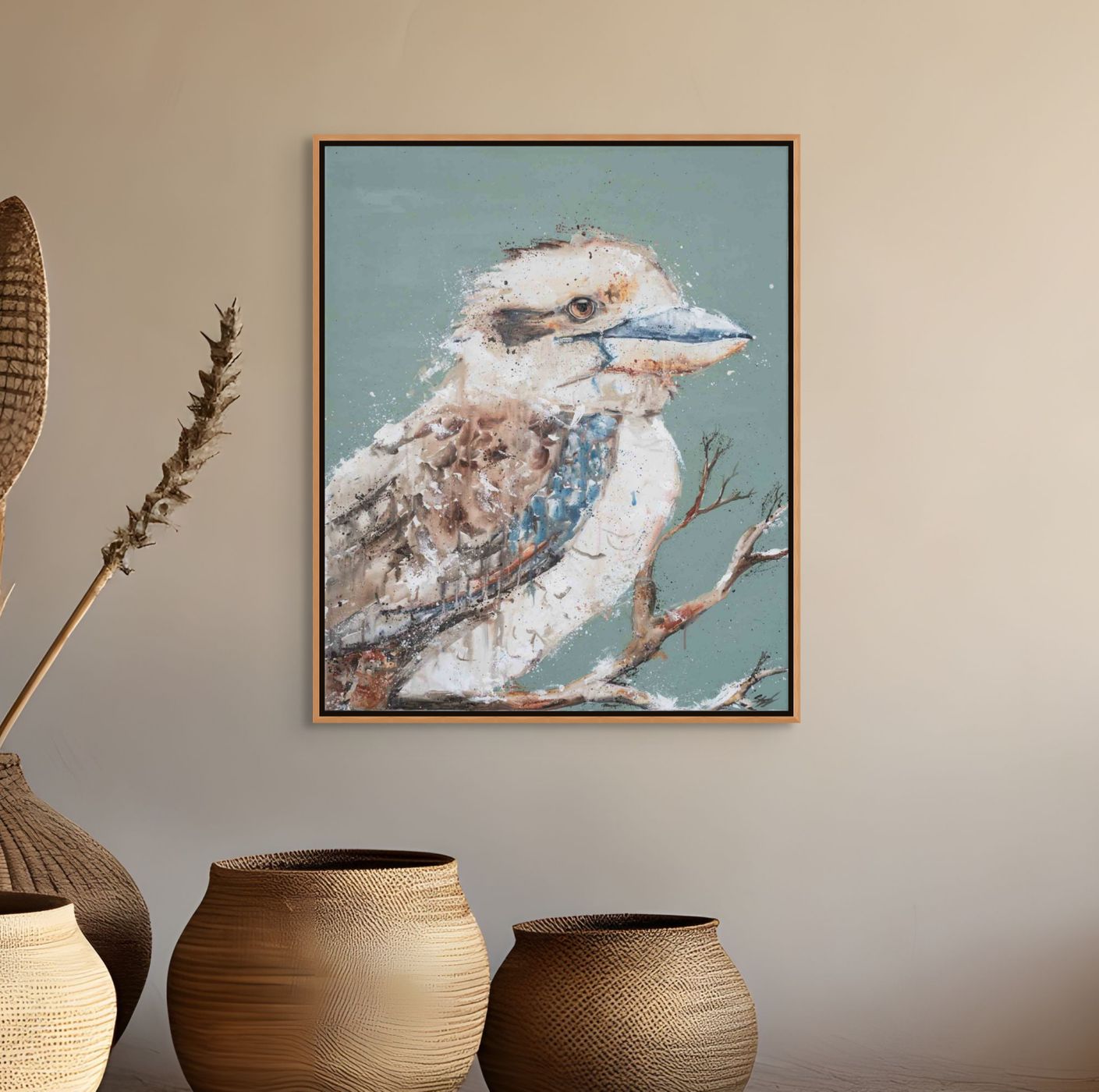 Framed artwork of a kookaburra on a wall with decorative vases below.