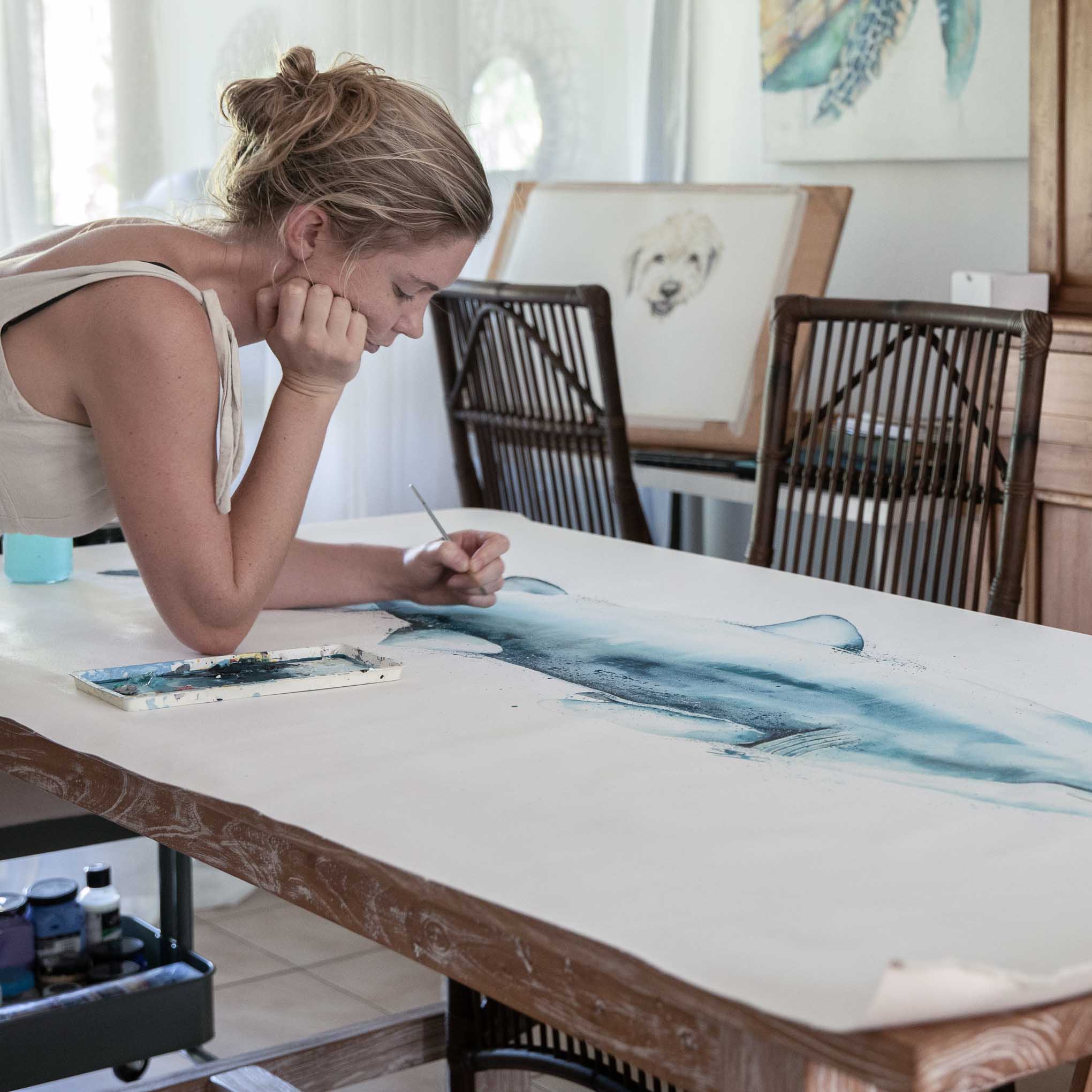 Stephanie Elizabeth painting on a giant shark canvas
