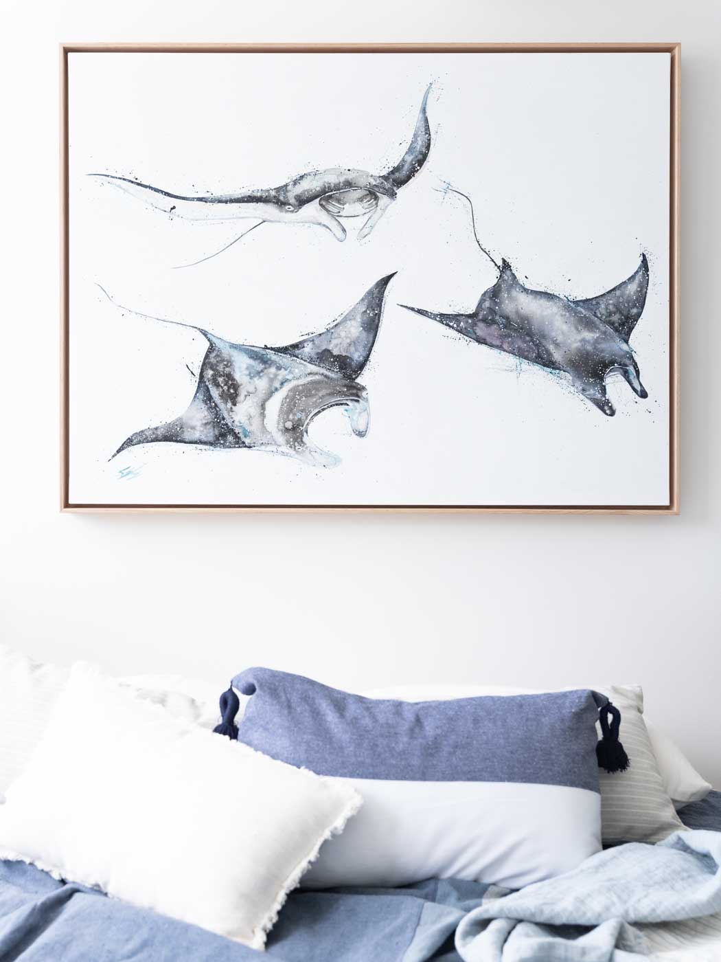 three manta rays painted on canvas framed in oak